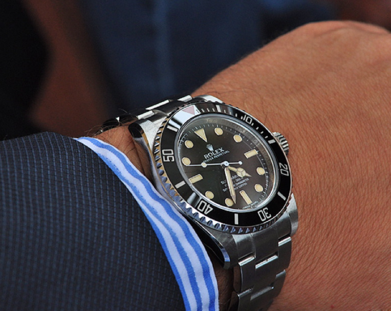 rolex-submariner-114060-dive-watch-on-hand-with-sleeve-1024x636